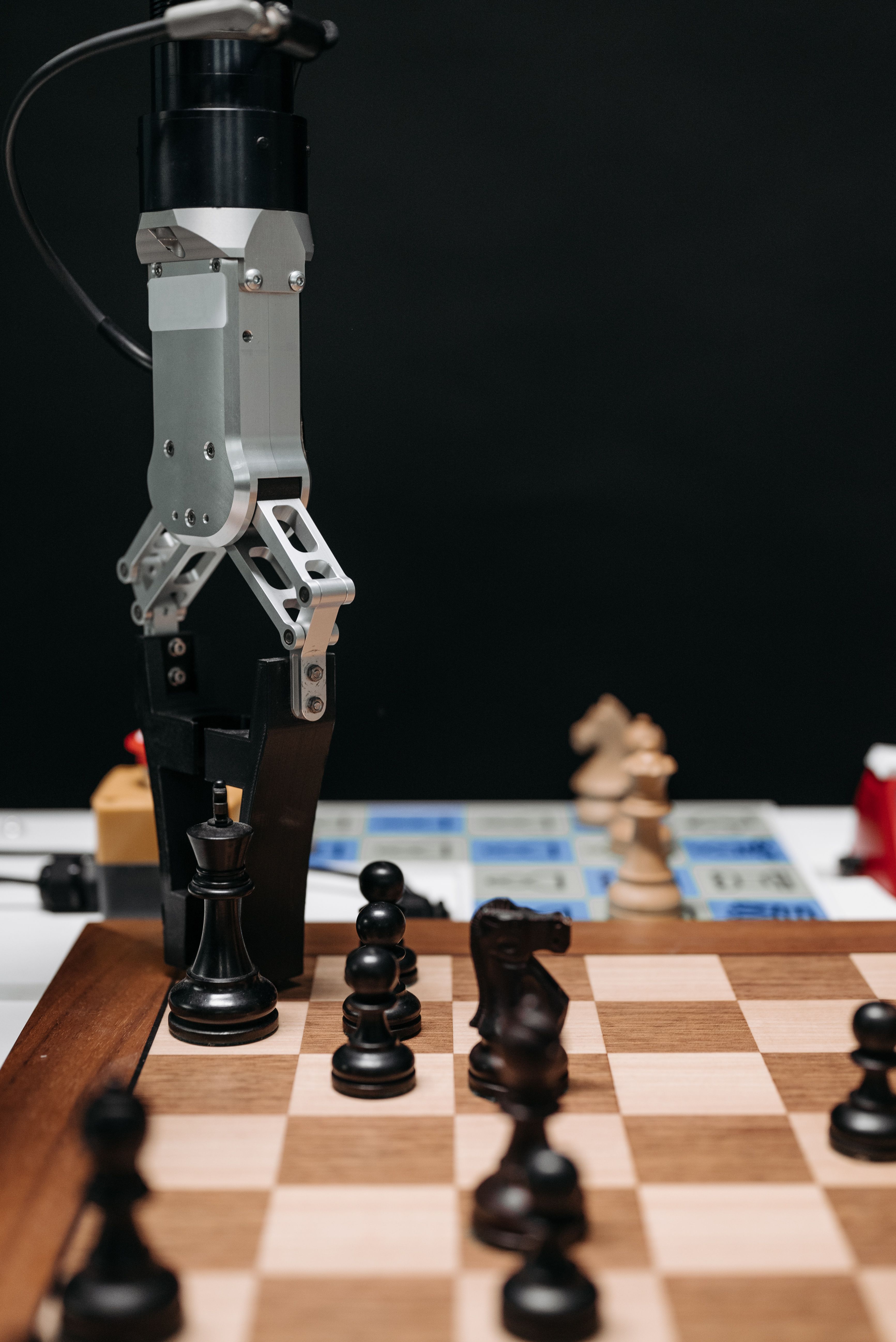 A robot gripper moving a chess piece in a manipulation experiment